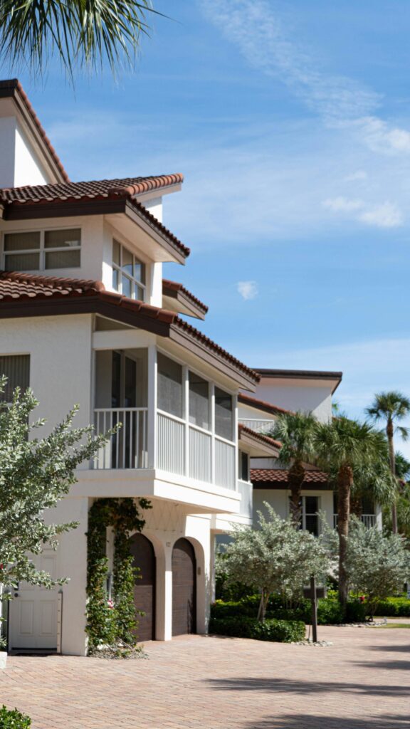 Modern Florida homes with palm trees highlighting the market students enter after passing the Florida real estate exam.
